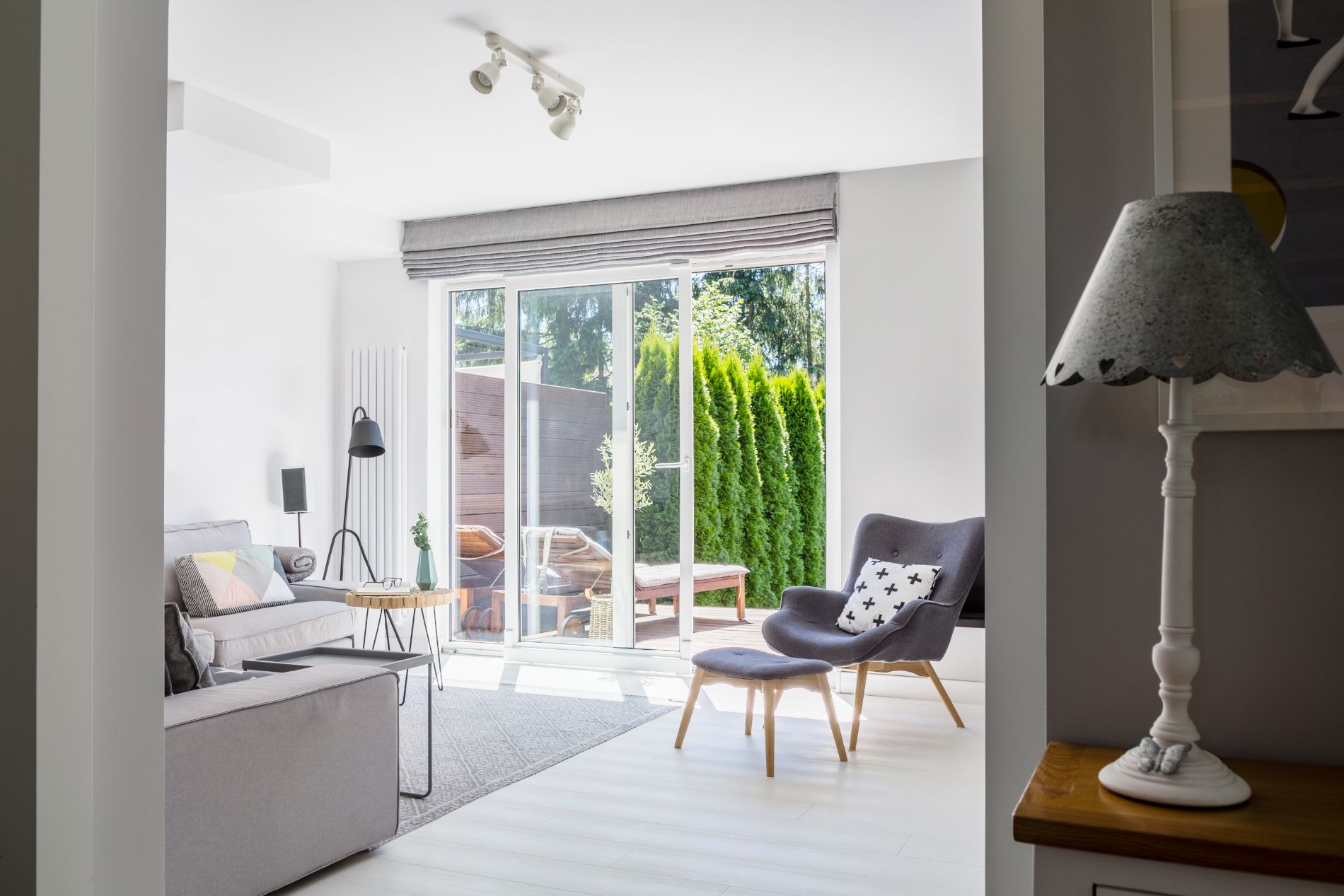 lamp-on-cabinet-and-windows-in-white-living-room